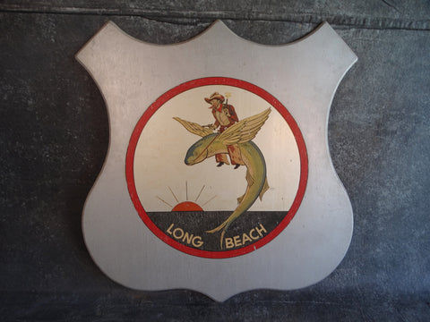 Folk Art Long Beach Shield - A Cowboy Riding a Flying Fish - 1930s P2670