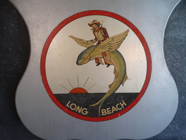 Folk Art Long Beach Shield - A Cowboy Riding a Flying Fish - 1930s P2670